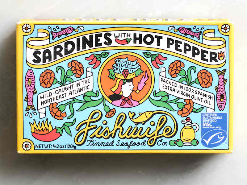 Colorful packaging for sardines with hot pepper, featuring floral designs and seafood illustrations.