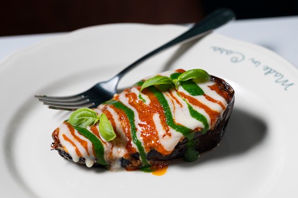 Eggplant parmigiana striped with Napoli sauce, cheese and basil.