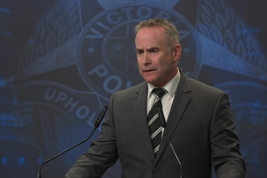 Chris Murray adresses media at a police press conference.