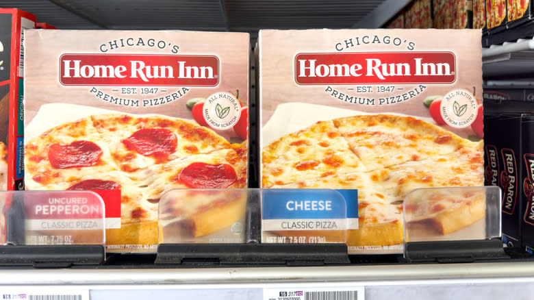 Several varieties of Home Run Inn Pizzas are displayed in a grocery store cold case