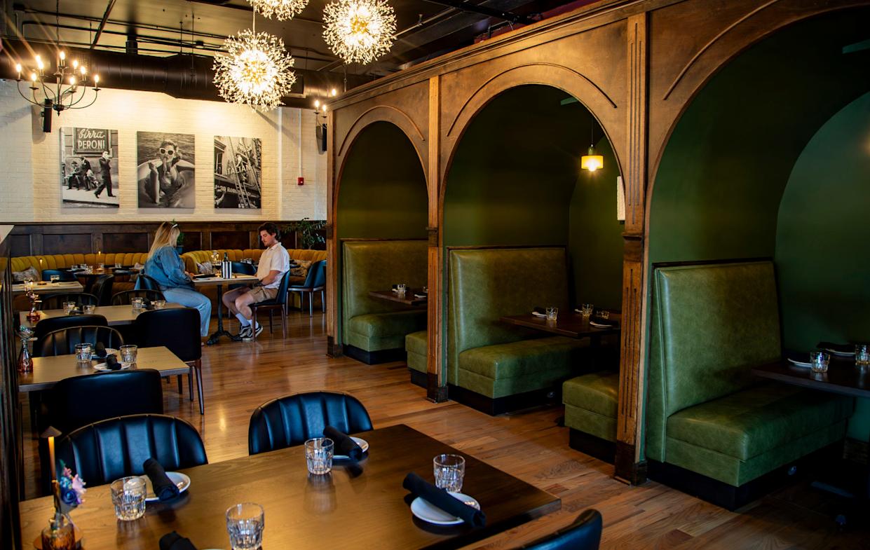 Guests sit inside Gemelli during a preview event at the restaurant in Asheville’s Biltmore Village on April 13, 2026, ahead of its grand opening.