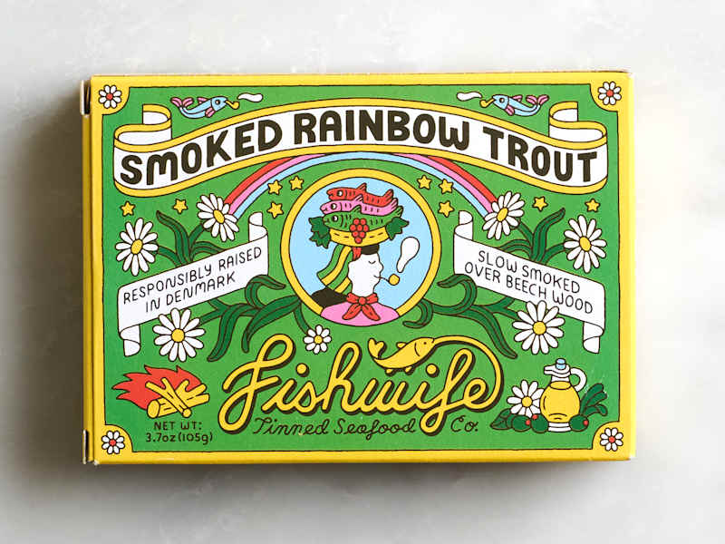 Colorful packaging for smoked rainbow trout featuring whimsical illustrations, flowers, and text about its sourcing and preparation.