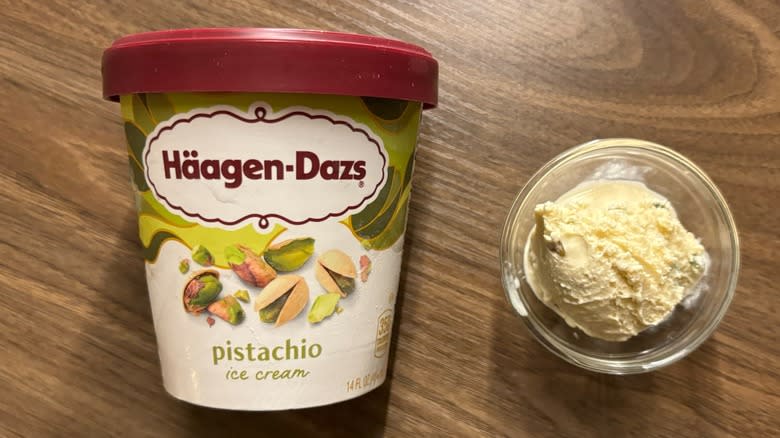 Häagen-Dazs Pistachio Ice Cream carton next to ice cream in glass ramekin