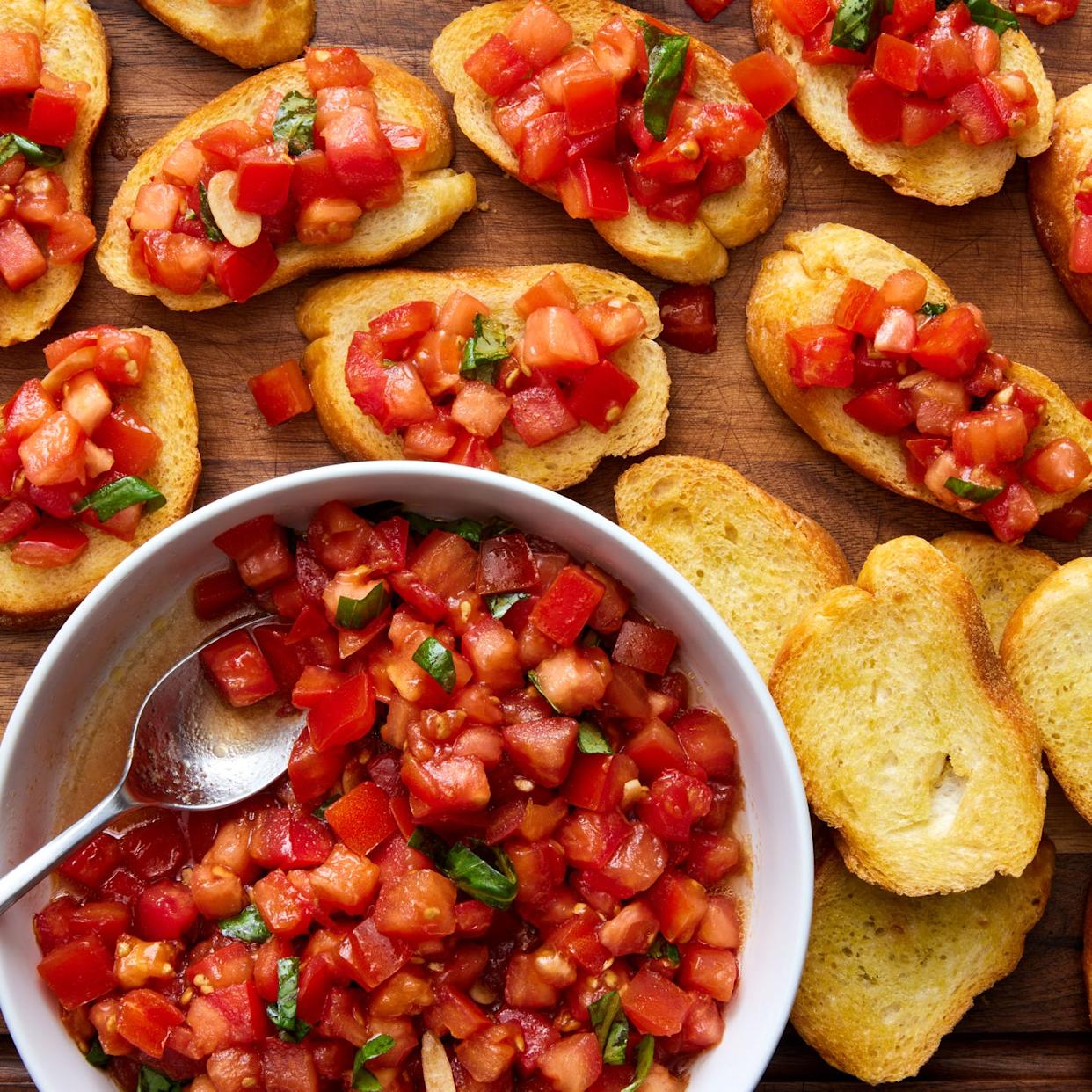 bruschetta spooned on top of slices of a toasted baguette
