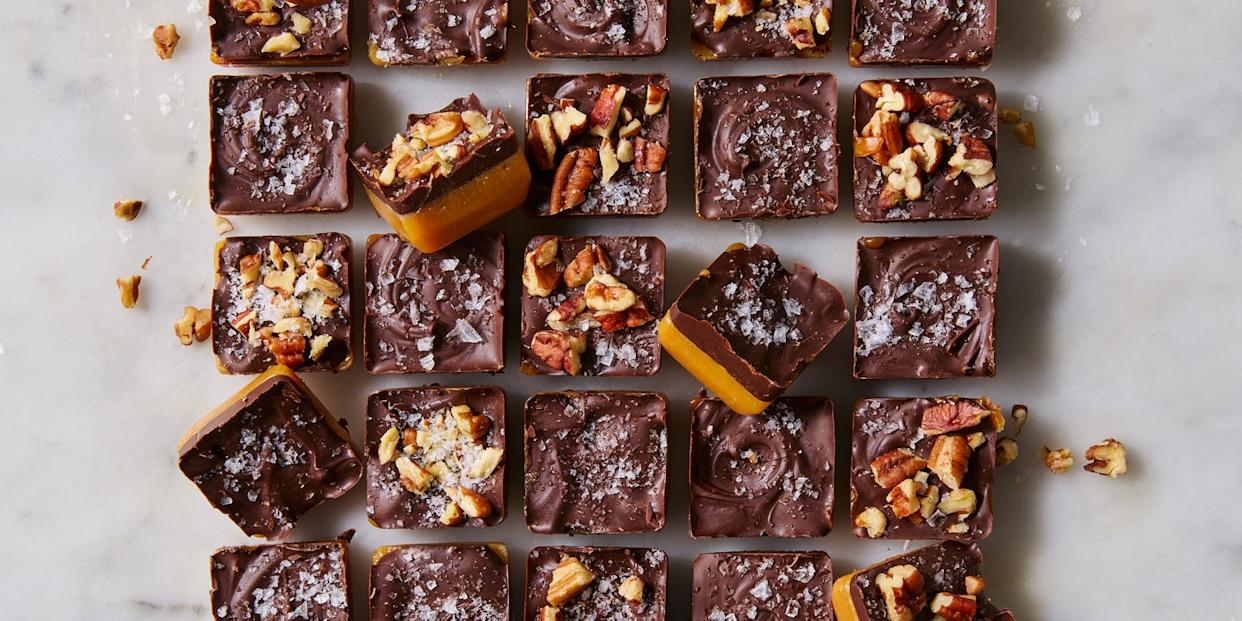 chewy toffee bites topped with flaky sea salt and chopped pecans