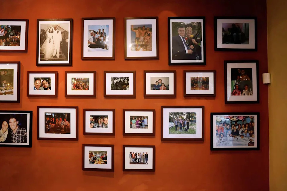 Photos from chef-owner Onur Akan’s life are displayed on a wall of his new Mediterranean restaurant Alara in the Dallas Design District. (Tom Fox/The Dallas Morning News)