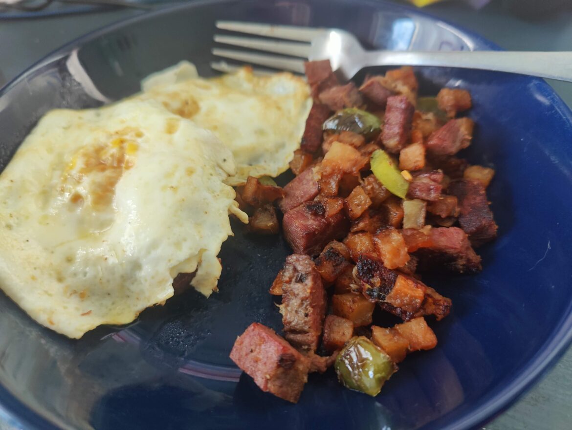Homemade corned beef hash with fried eggs