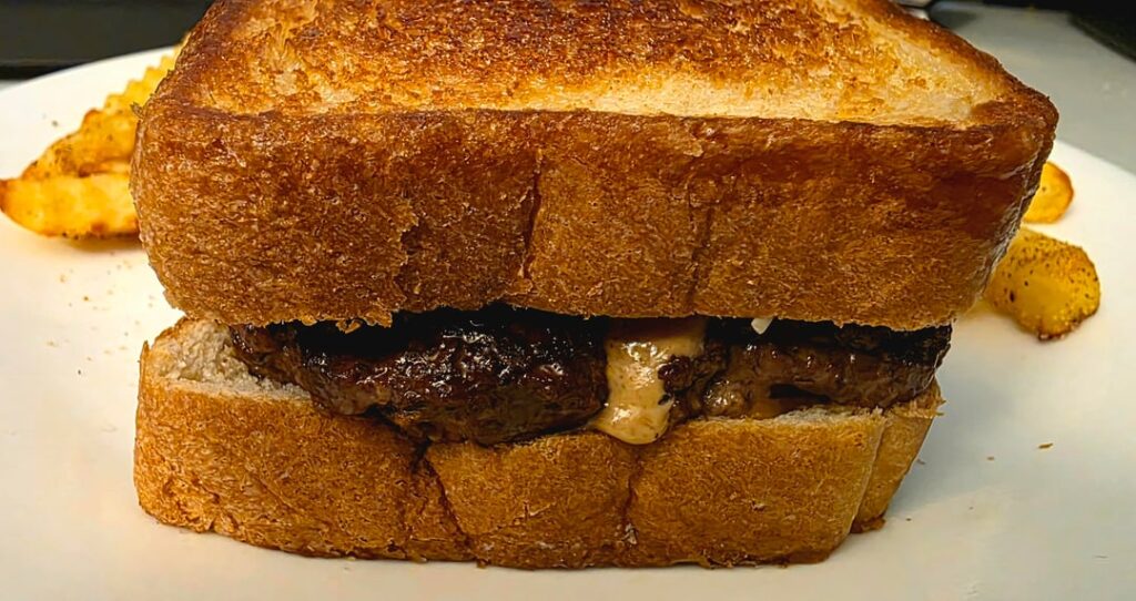 Half-pound 5-cheese Texas toast burger with savory horseradish mayo