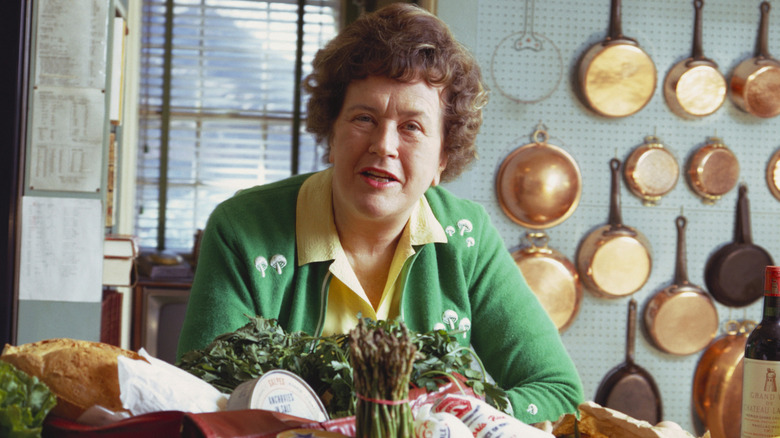 Julia Child sitting in kitchen