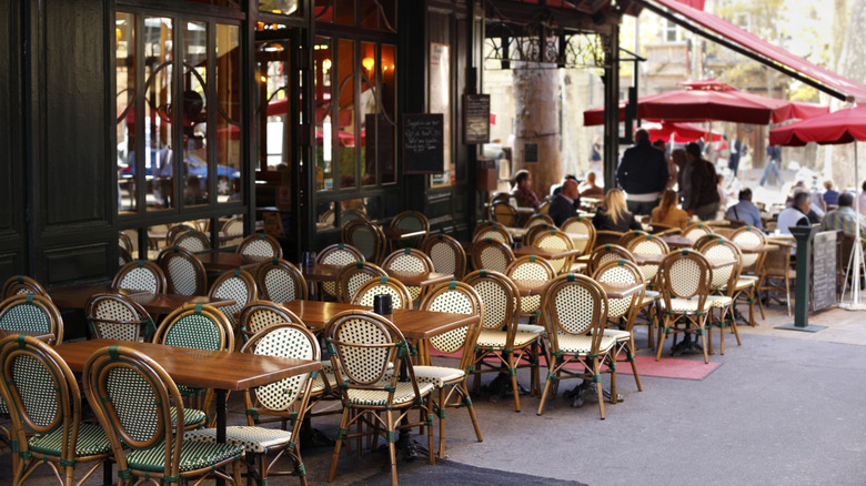 Outdoor seating at a French restaurant in what appears to be Paris.