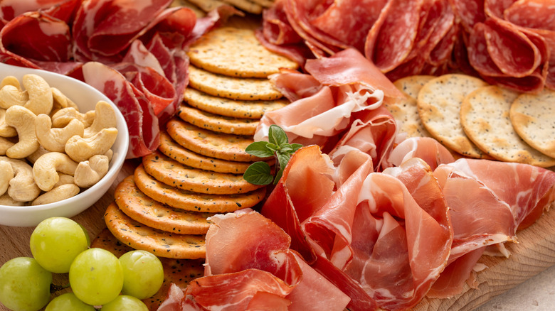Charcuterie board with meats, cheeses, and crackers