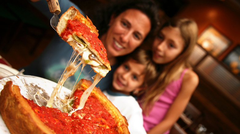 A family eating deep dish pizza in Chicago