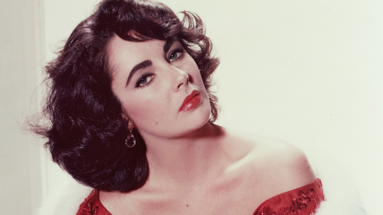 Elizabeth Taylor in a red dress with a white fur wrap