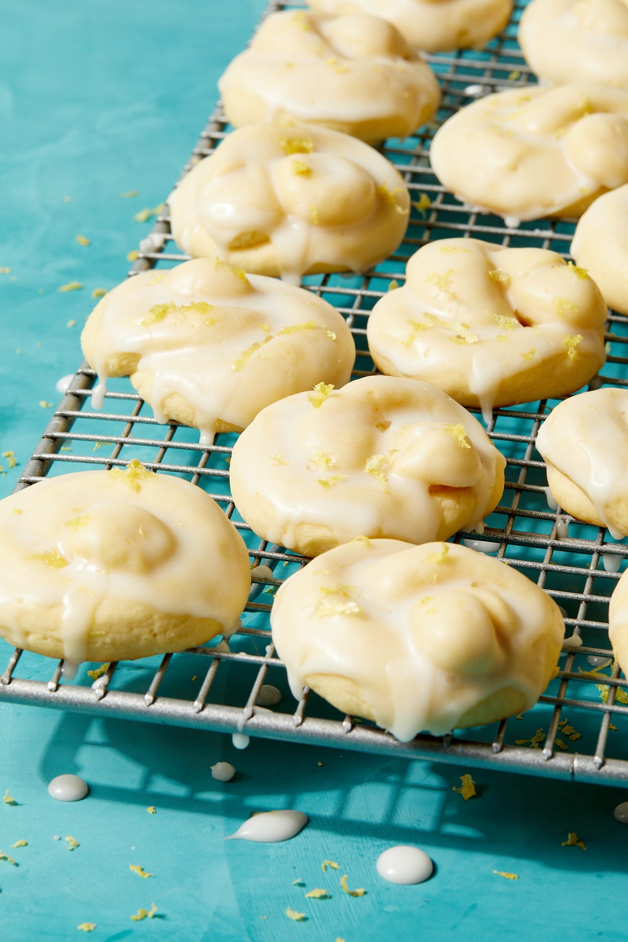 italian lemon cookies covered in an white icing glaze and lemon zest