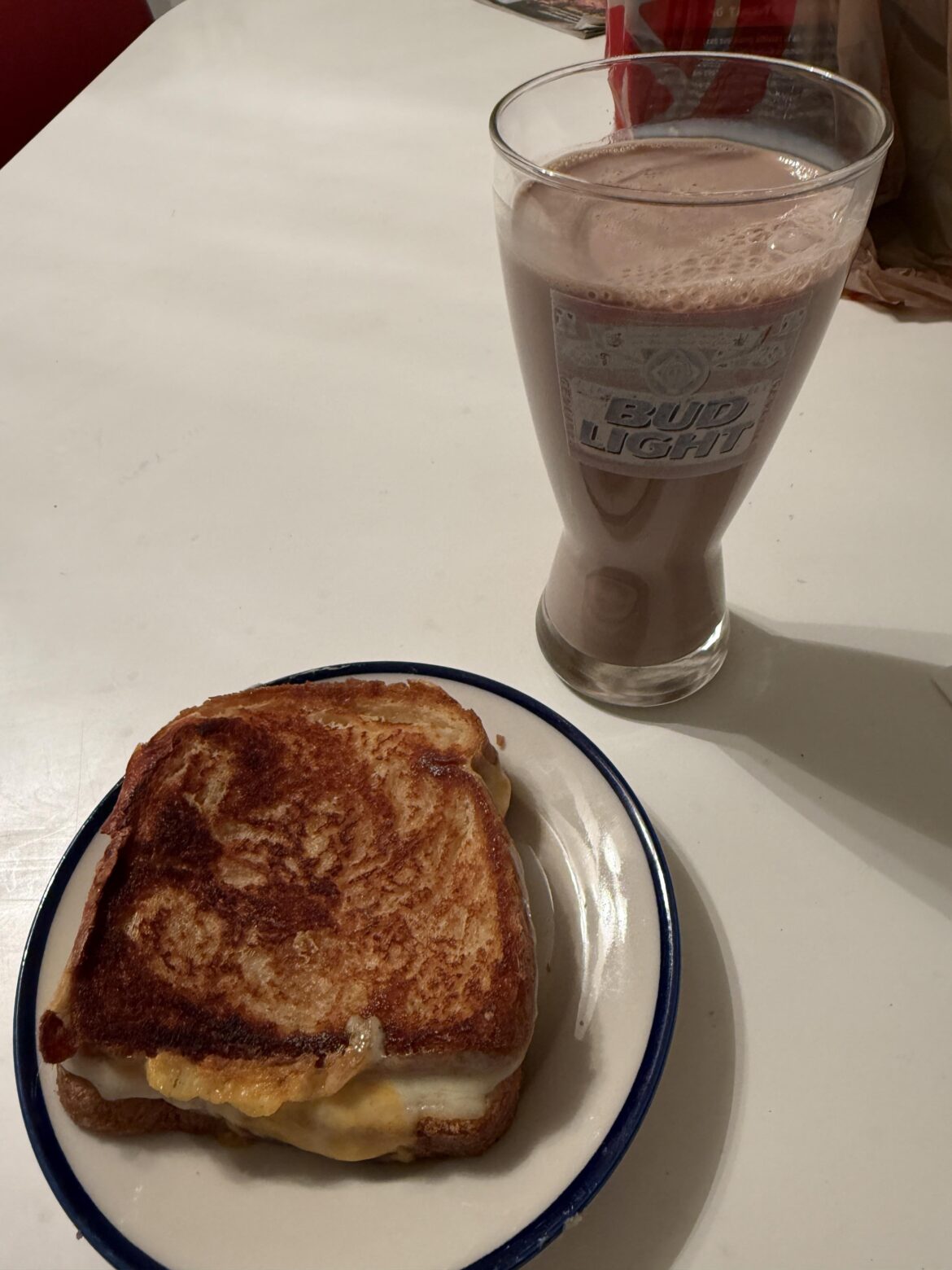 two slices of colby jack, two slices of pepper jack, a glass of chocolate milk