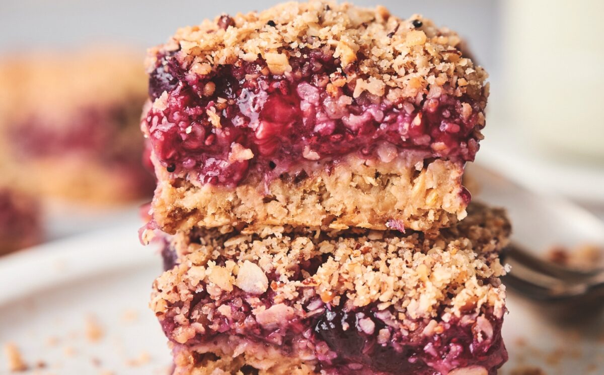stacked breakfast berry chia bard with banana, maple syrup, rolled oats, frozen berries, and a crumble topping for most popular breakfast recipes