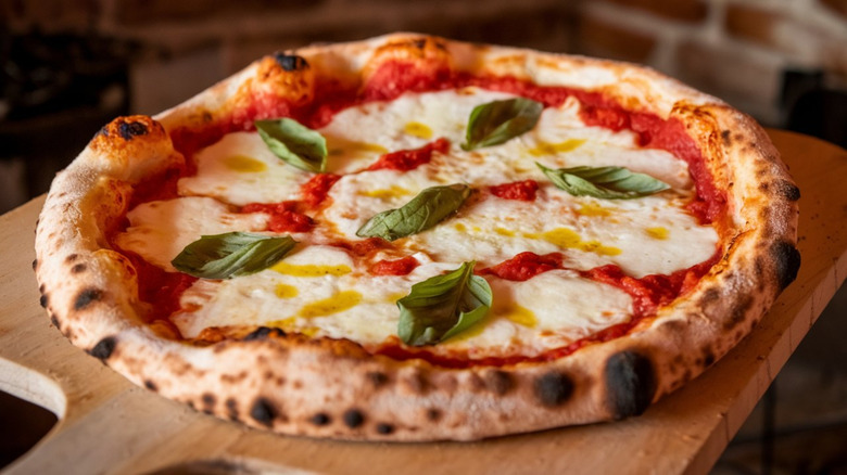 Traditional margherita pizza with basil and olive oil