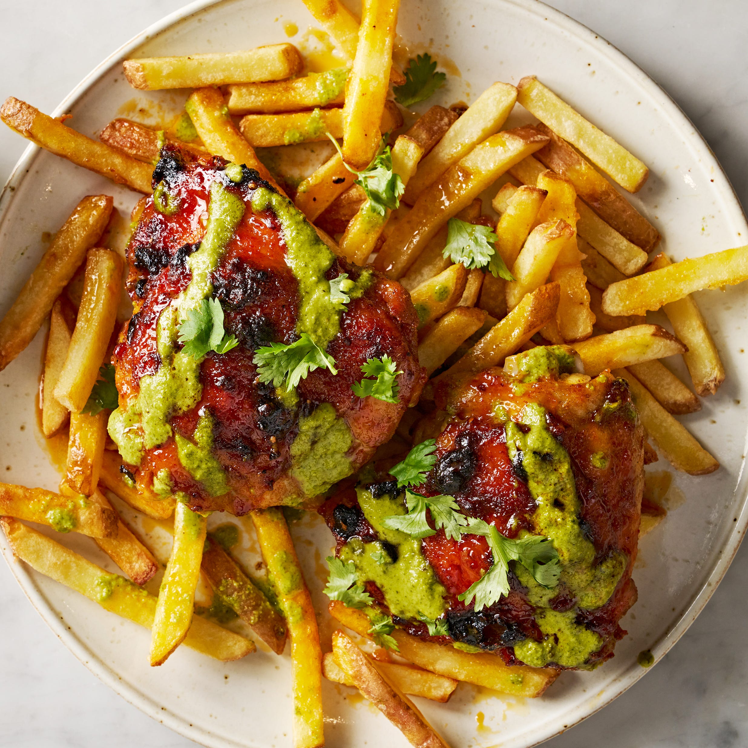 peruvian style chicken drizzled with green sauce and served with lime