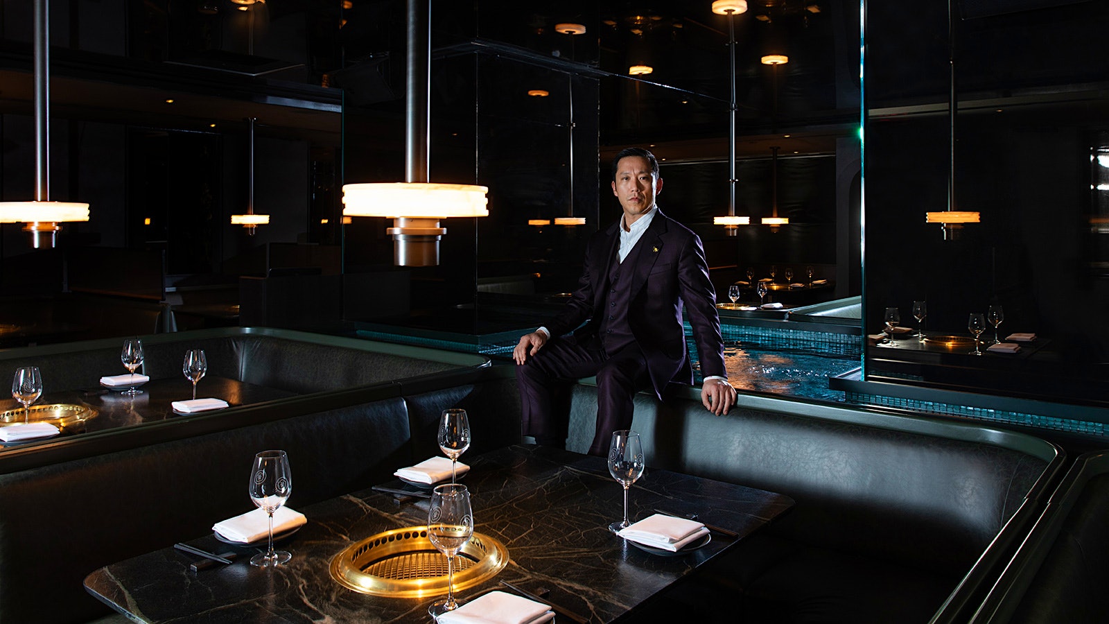  Simon Kim sitting at a booth at Cote.