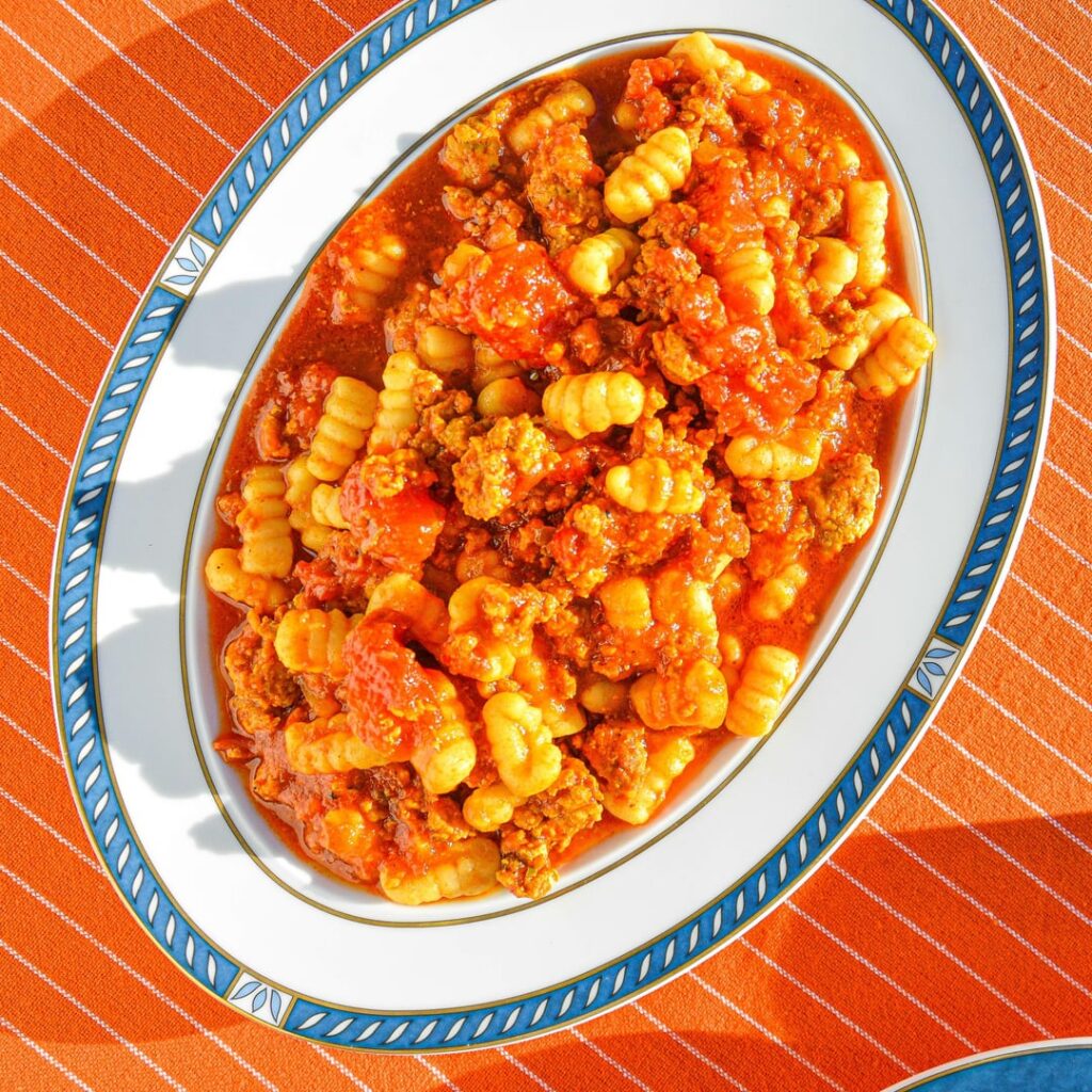 Malloreddus alla Campidanese -  Sardinian ridged pasta with pork ragù, fennel seeds, saffron, and tomatoes