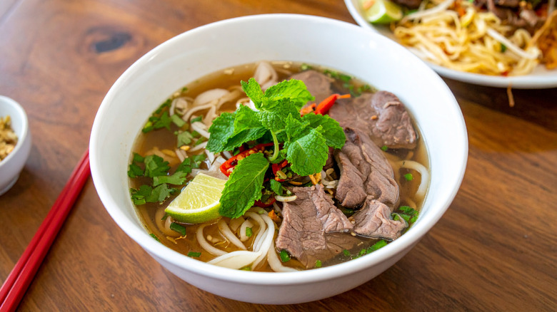 A bowl of Vietnamese pho on a table