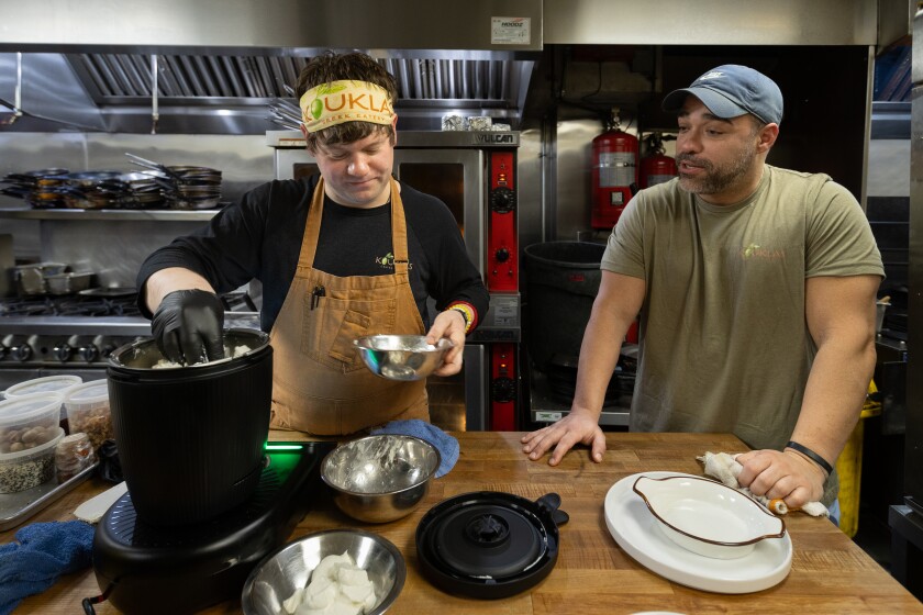 Kevin Stack, left, and Jimmy Banos Jr., chef-partners at of Kouklas Greek Eatery in Niles, prepare whipped feta.