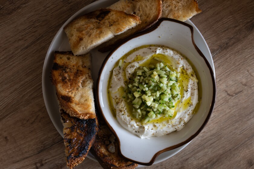 Bannos Jr. and Stack's whipped feta recipe is pictured with cucumber, olive oil and Greek oregano garnishings.