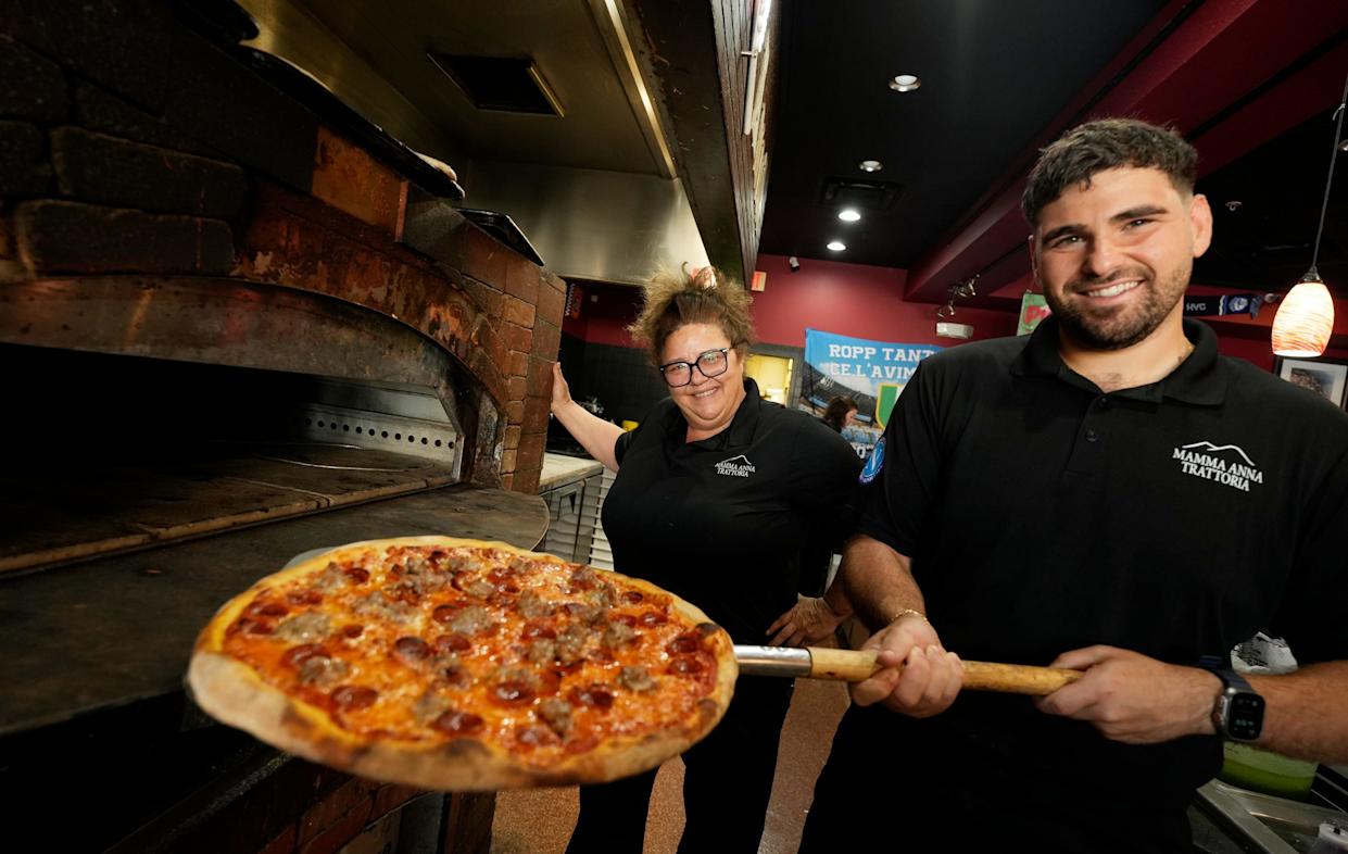Owner Anna Maria Longobardi poses with Vincenzo Schiano Lomoriello, one of her three sons, at Mamma Anna Trattoria at Coconut Point in Estero.