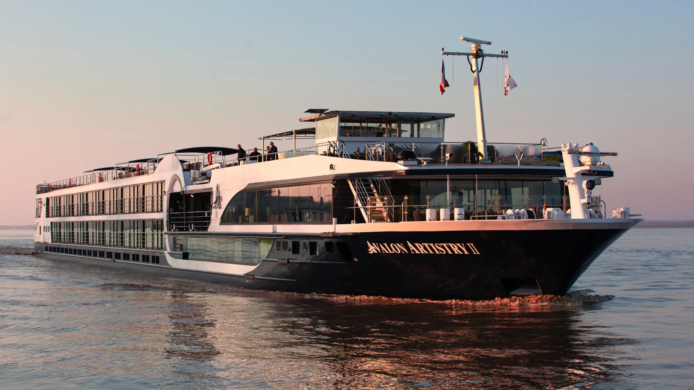The Avalon Artistry II river cruise ship travels through the water.