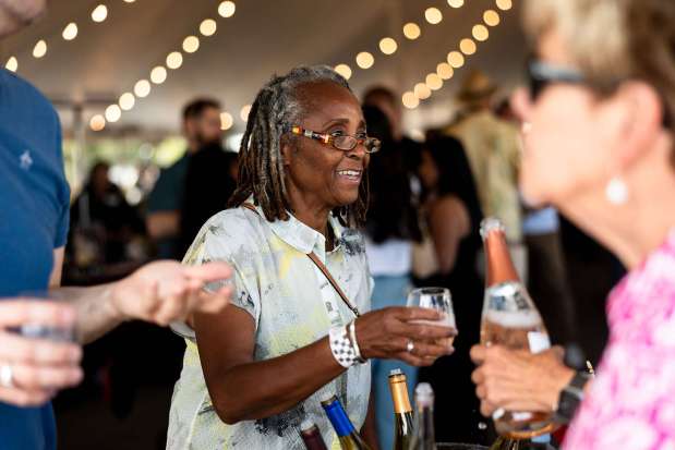 Delores Hayes tastes wine from Roche at The North Coast Wine & Food Festival at Luther Burbank Center for the Arts in Santa Rosa, Saturday, June 14, 2025. (Loren Hansen / For The Press Democrat)
