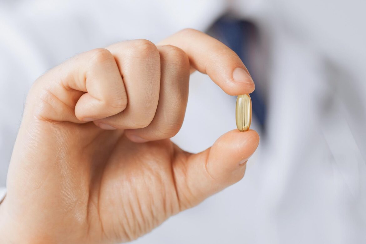 Popular Supplement Ingredient Linked to Shorter Lifespan in Men Doctor Holding Vitamin Supplement Medicine Capsule