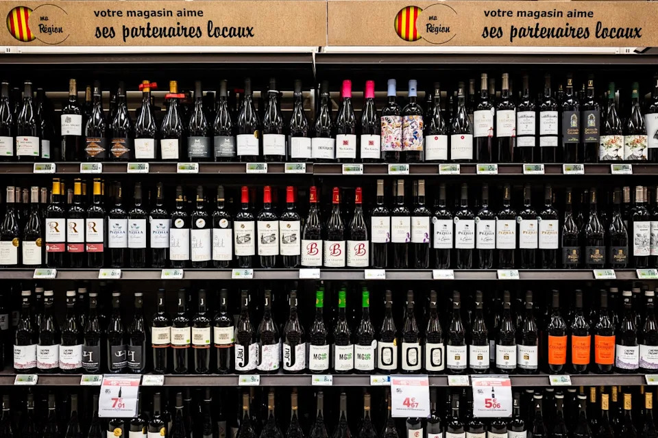 Tariffs imposed by the United States, the world's largest wine market, by President Donald Trump since last year have added to difficulties for a sector grappling with a harsher climate and waning demand (A wine aisle at a Carrefour in Perpignan on 15 May pictured, file) (AFP/Getty)