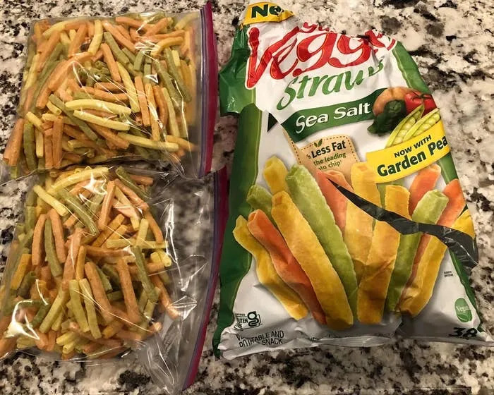 Veggie Straws snacks in two bags and an open, empty Veggie Straws bag on a kitchen counter