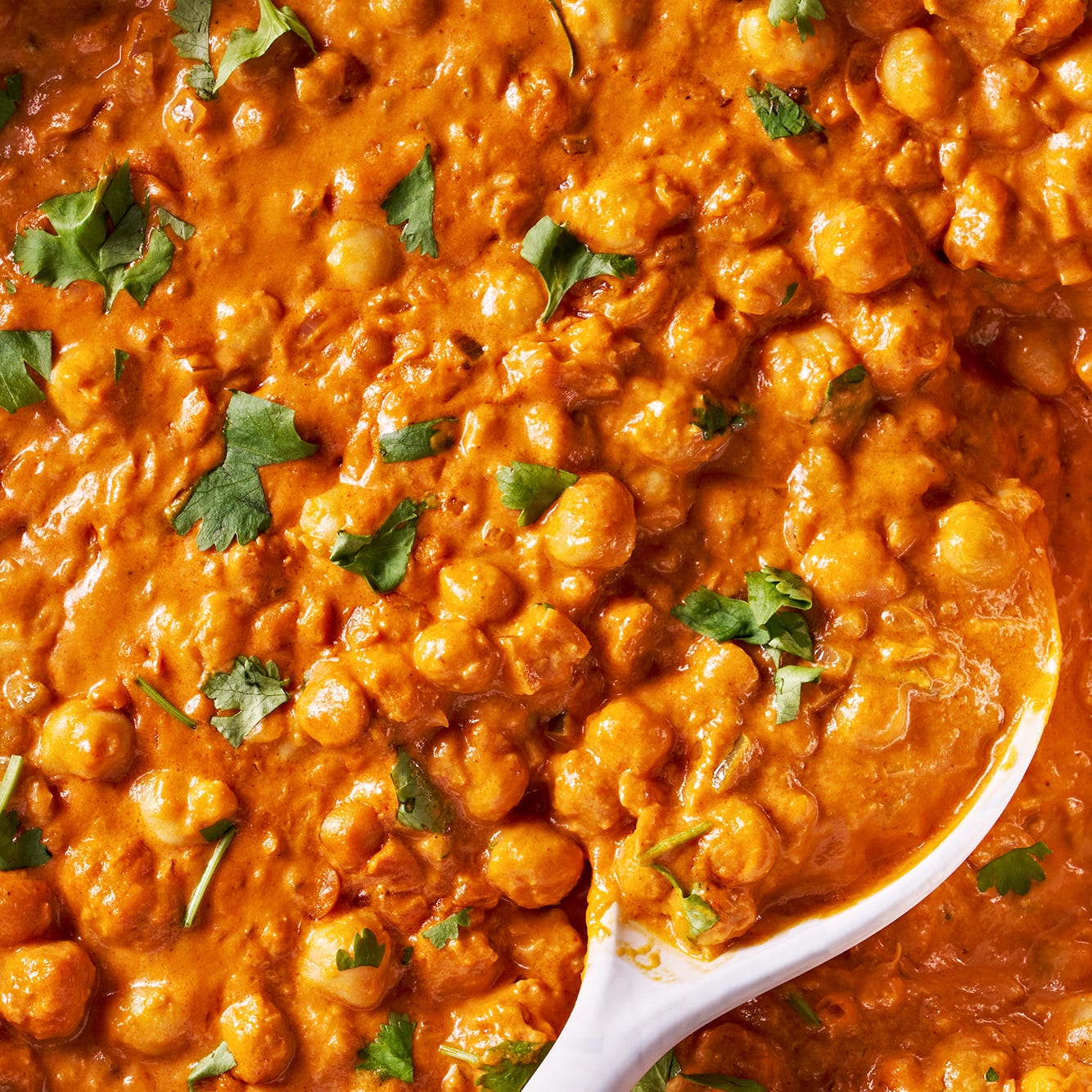 indian butter chickpeas with a spoon