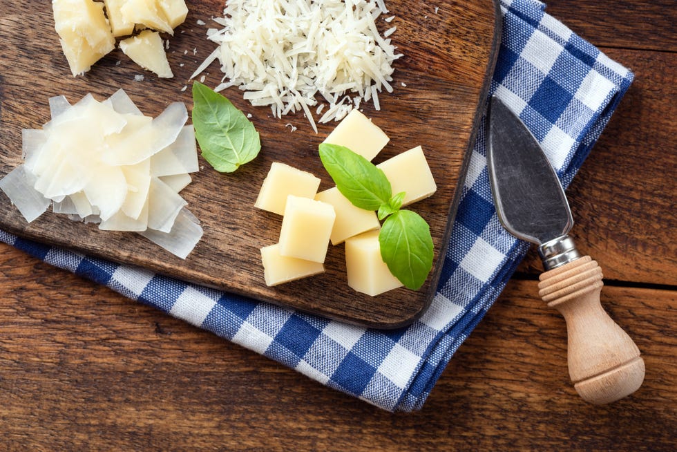 italian cheese parmesan or parmigiano reggiano in different shapes, grated cubed and flaked