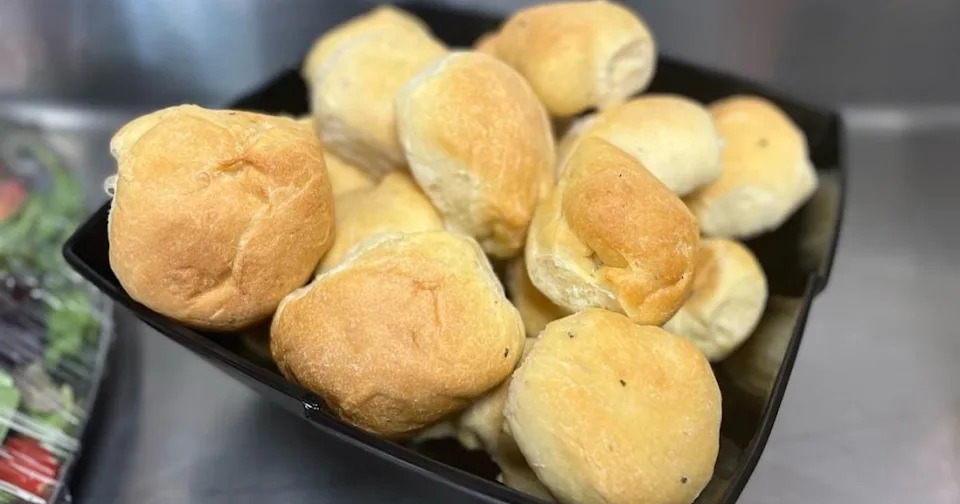 CLoseup of a pile of warm dinner rolls in a bowl from Sophia's Tuscan Grille in Warwick, Rhode Island