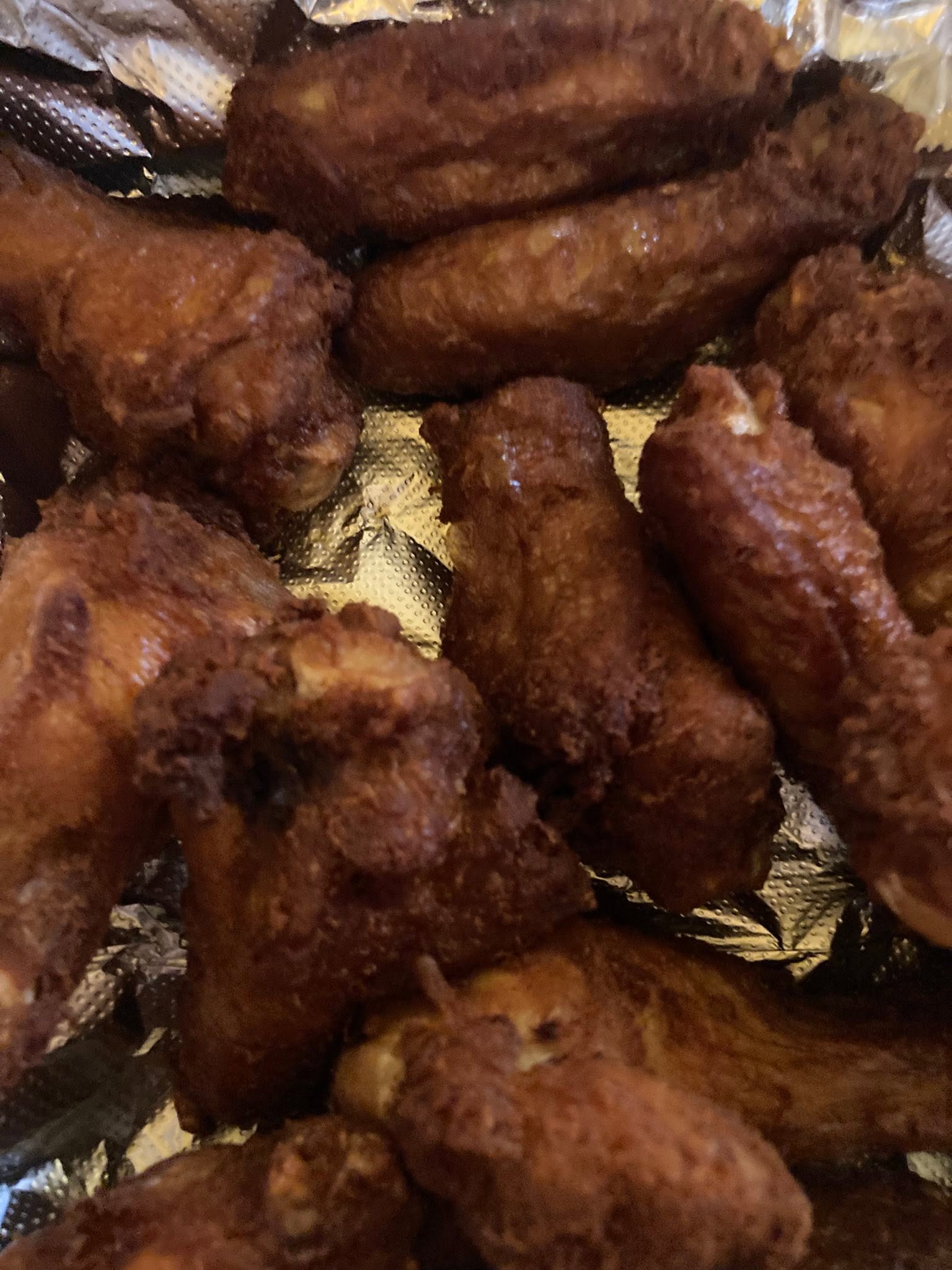 A tray filled with freshly fried chicken wings from Fisher of Men seafood truck in Alexandria.