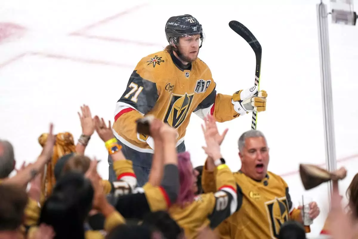 Vegas Golden Knights center William Karlsson and fans celebrate his goal during the second period in Game 4 of the NHL hockey Stanley Cup Final series against the Carolina Hurricanes, Tuesday, June 9, 2026, in Las Vegas. (AP Photo/Candice Ward)