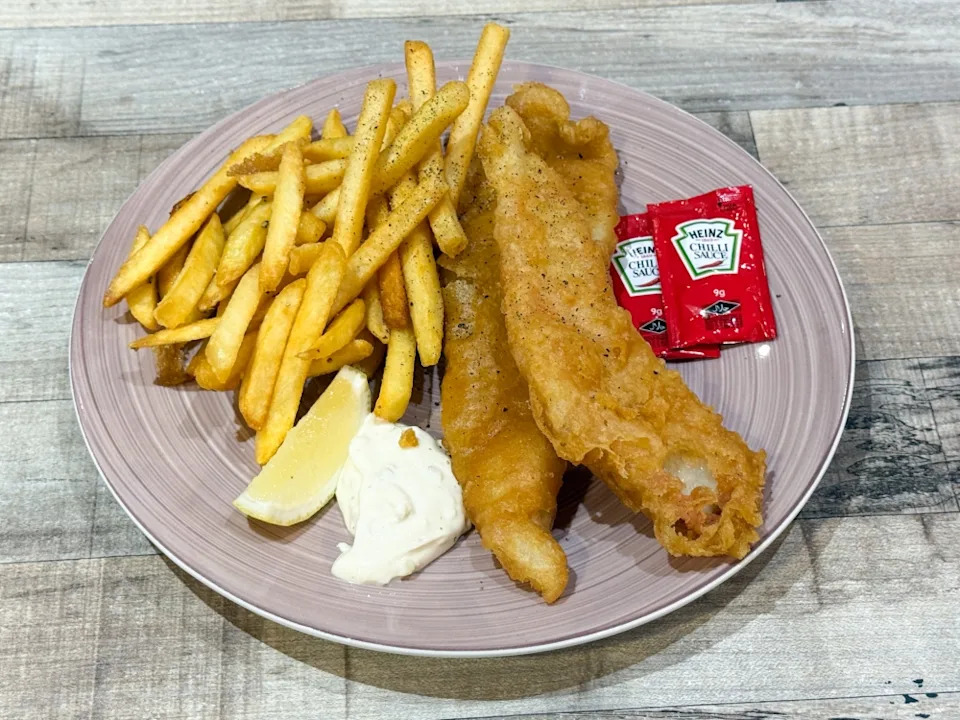 Classic Fish and Chips features fried fish encased in a thin, crispy batter with fries and their homemade tartar sauce — Picture by Lee Khang Yi