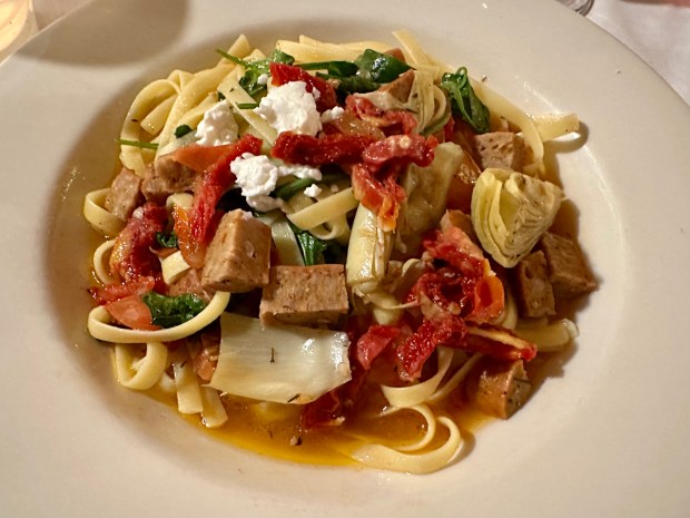 Pinocchio linguine is a house specialty, pairing shrimp, artichoke hearts, sun-dried tomatoes, spinach and chèvre cheese in white wine garlic sauce. Add sausage to make the dish heartier. (Greeley Tribune file photo)
