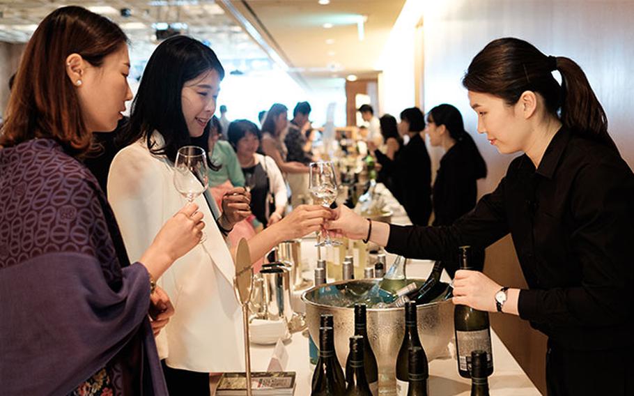 Two women taste wine at the New Zealand Wine Festival.