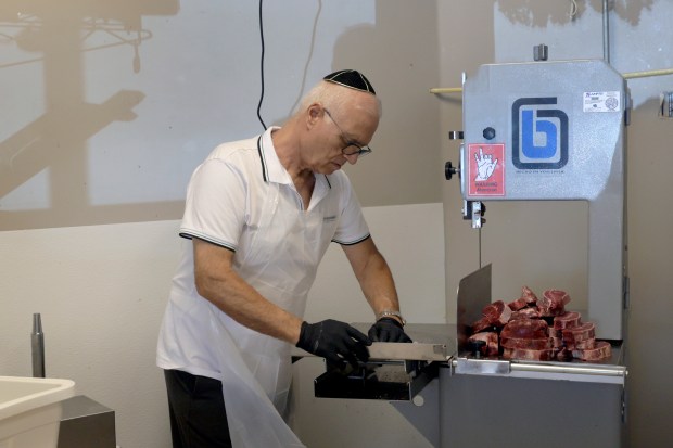 Yaish Dahan cuts meat at Eden Kosher Meat Market in Hallandale Beach, Wednesday, June 17, 2026. (Mike Stocker/South Florida Sun Sentinel)