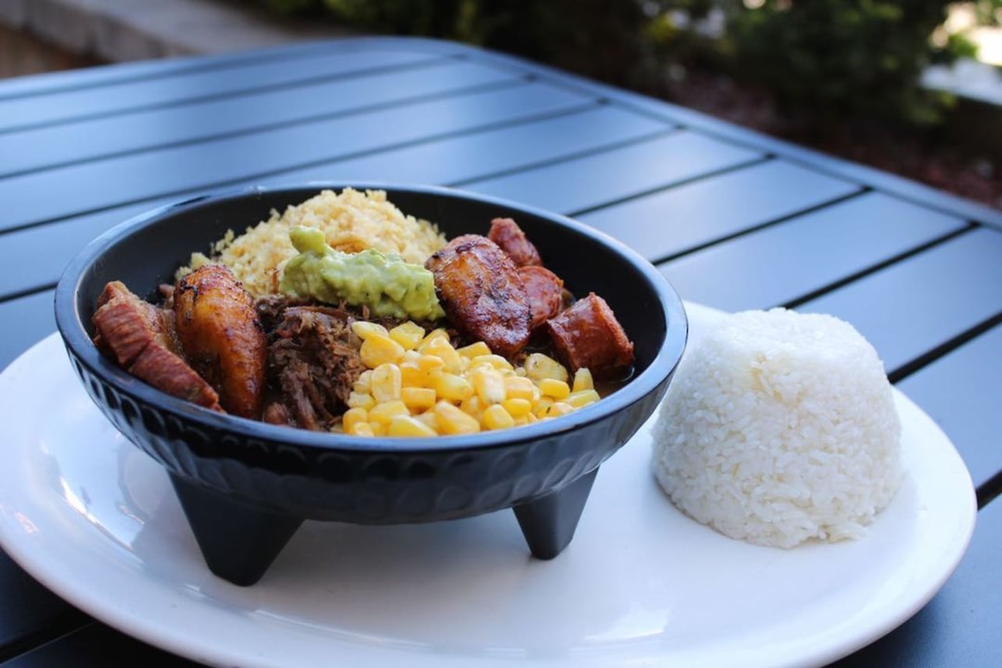 The Cazuelita, which can be done with either ground beef or shredded chicken with beans, sweet plantains, fried pork rinds, sausage, and rice at La Casona in Central Falls, Rhode Island. 