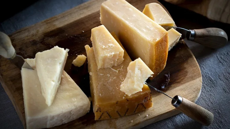 parmesan and romano cheeses on cheese board