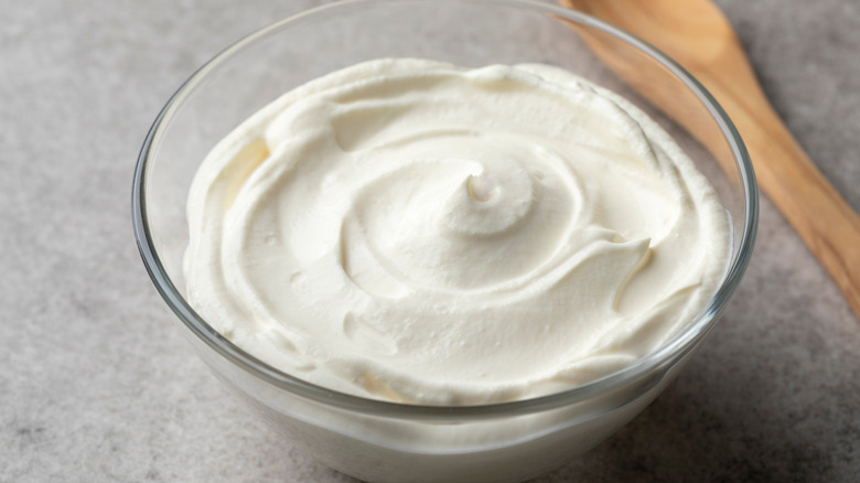 glass bowl of creme fraiche near spoon