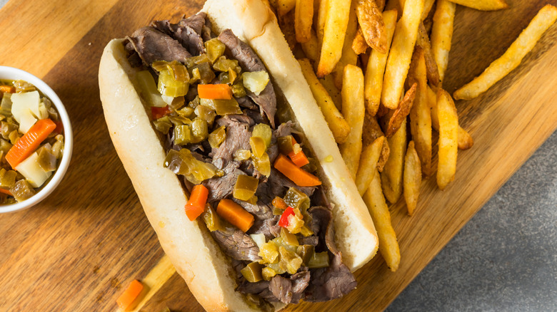 Dry Italian beef sandwich dressed with giardiniera and fries on the side.