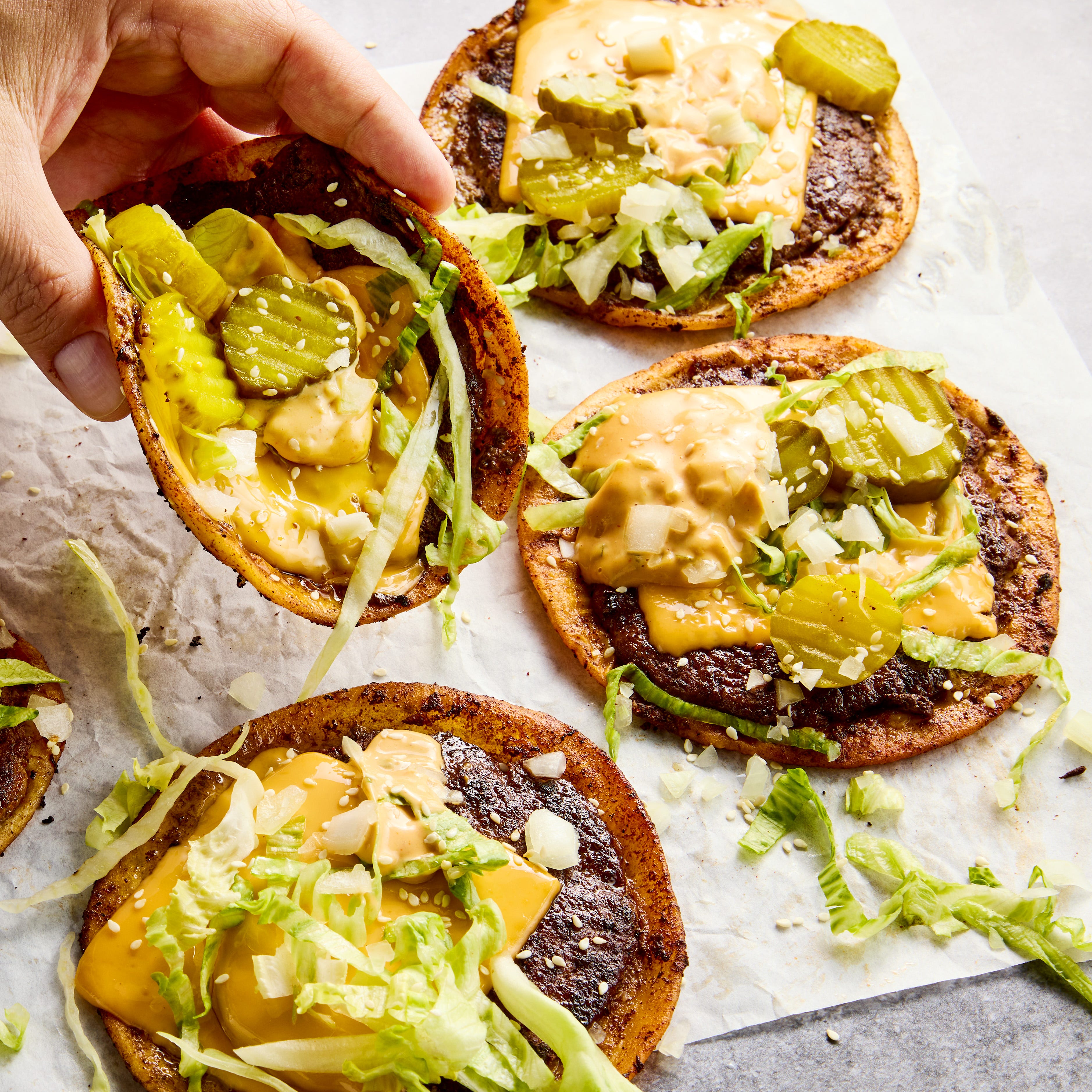the ultimate comfort food hybrid with a crispy, juicy, thin beef patty, melty american cheese, and all the classic burger fixings loaded onto a toasted flour tortilla