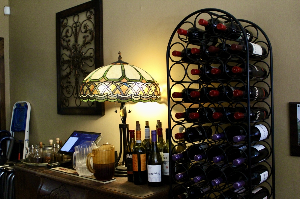 wine rack next to a dim lamp