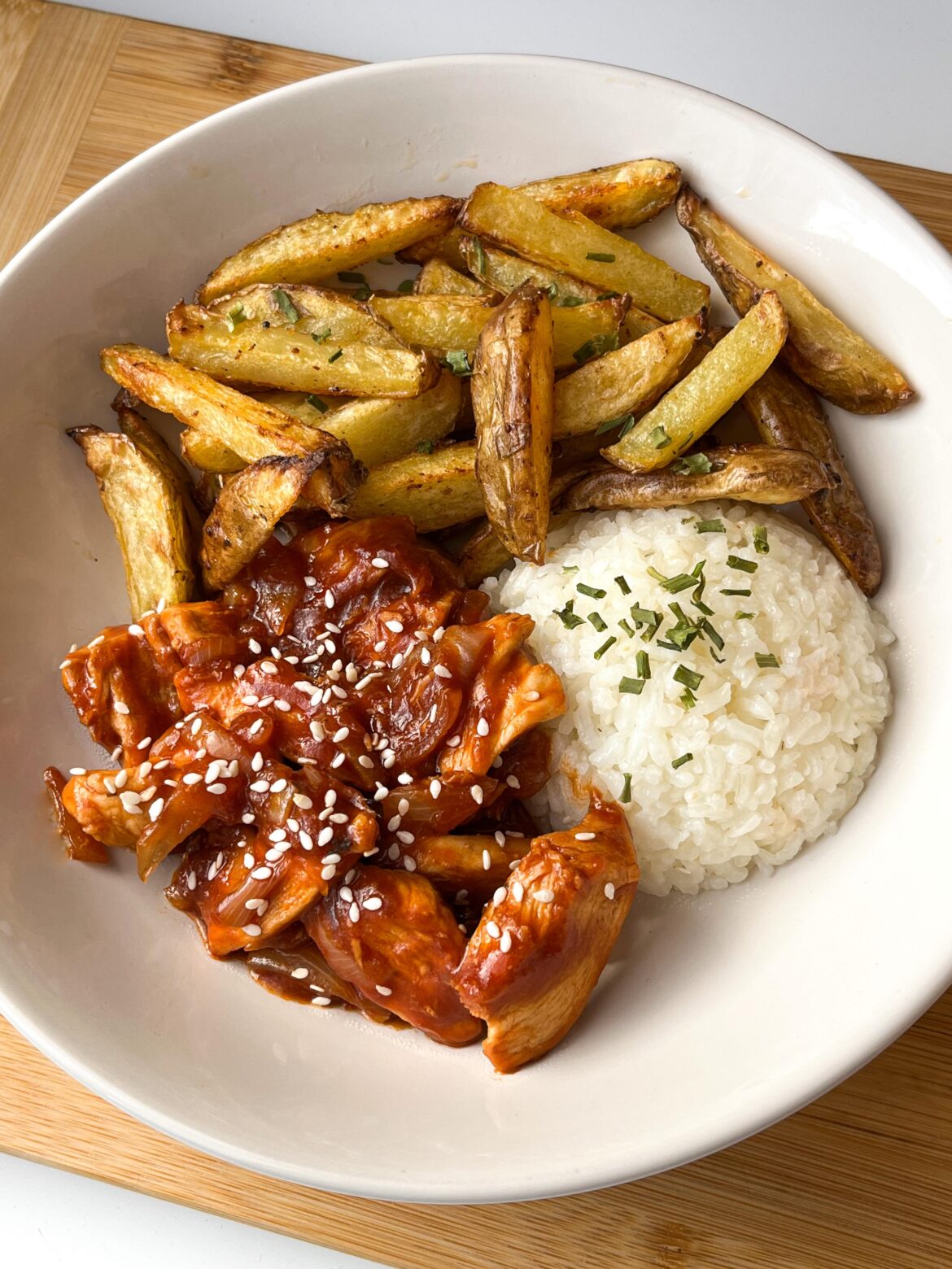 Sticky sesame chicken with rice and rustic fries