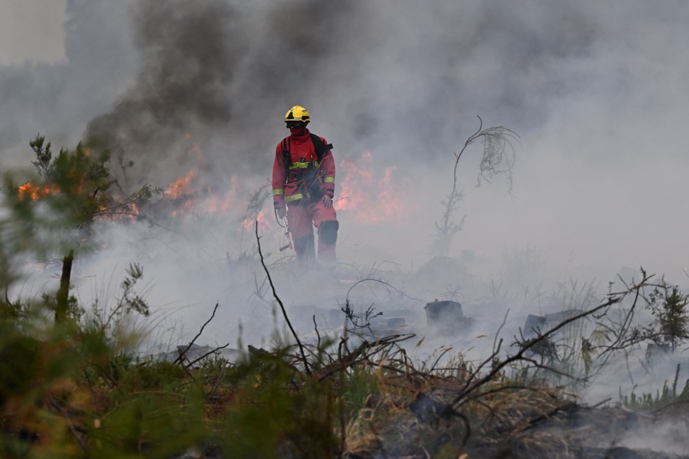 Firefighters battle a wildfire near Marcheprime, outside, Bordeaux, France, Sunday, July 26, 2026. (AP Photo/Emma Da Silva)